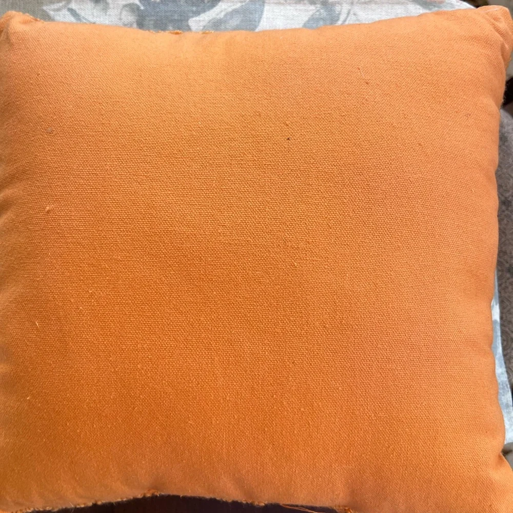 The Midnight Market Orange Knit seasonal pillow. Measures 12” by 12”